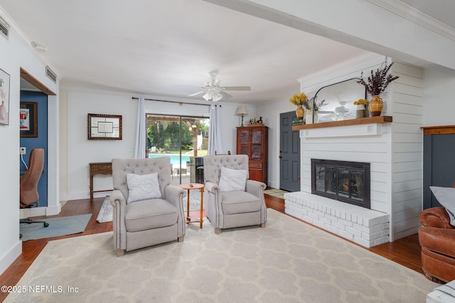 17459 Eagle Bend Blvd, Jacksonville, FL 32226 - living room featuring ornamental molding, wood finished floors, a fireplace, a ceiling fan, and baseboards