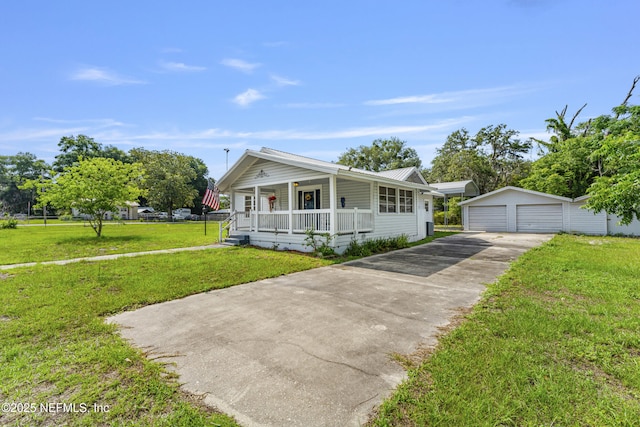 2505 State St, Palatka, FL 32177 - view of front of property featuring covered porch, an outdoor structure, a garage, a front yard, and metal roof