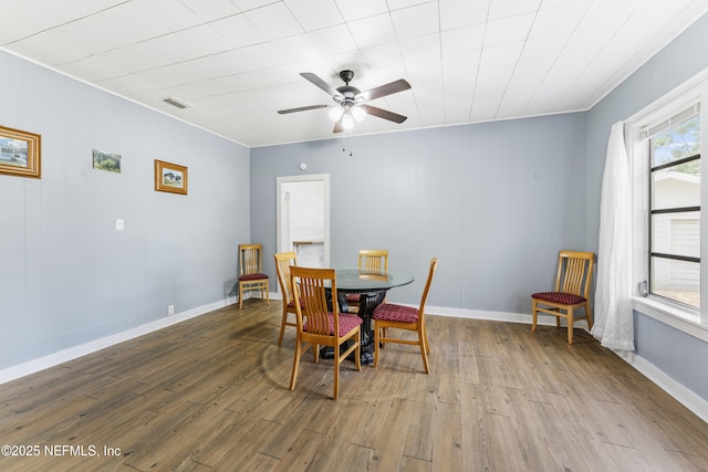 2505 State St, Palatka, FL 32177 - dining room featuring wood finished floors, a ceiling fan, and baseboards