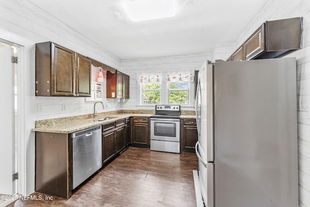 2505 State St, Palatka, FL 32177 - kitchen featuring stainless steel appliances, a sink, dark wood-style flooring, dark brown cabinets, and light stone countertops