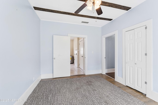 2505 State St, Palatka, FL 32177 - unfurnished bedroom with light wood finished floors, a closet, baseboards, and a ceiling fan