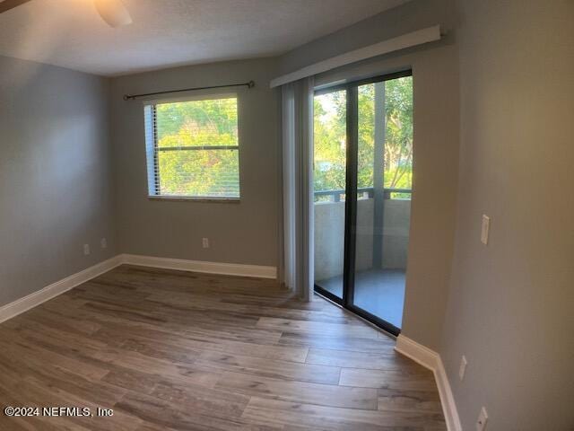 5615 San Juan Ave Unit 310, Jacksonville, FL 32210 - spare room featuring healthy amount of natural light, wood finished floors, ceiling fan, and baseboards