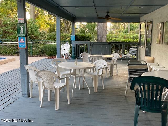 5615 San Juan Ave Unit 310, Jacksonville, FL 32210 - deck featuring ceiling fan and outdoor dining area