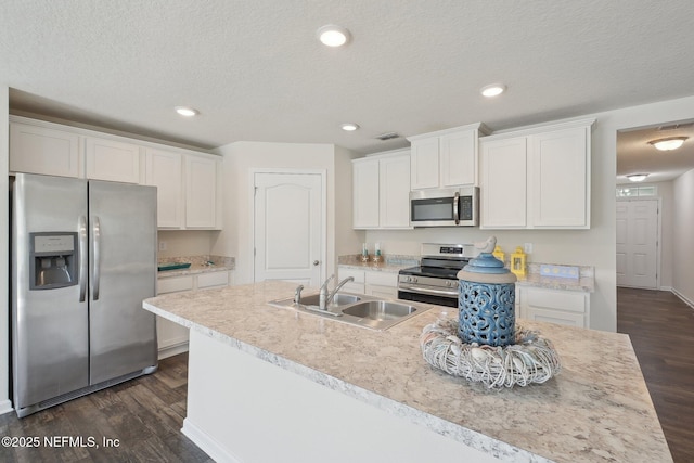 96 Cody St, Saint Augustine, FL 32084 - kitchen with appliances with stainless steel finishes, a sink, dark wood-style floors, white cabinets, and recessed lighting