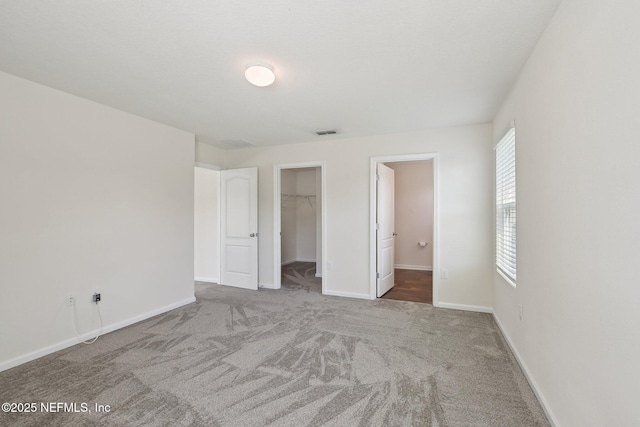 96 Cody St, Saint Augustine, FL 32084 - unfurnished bedroom featuring carpet floors, a spacious closet, baseboards, and a closet