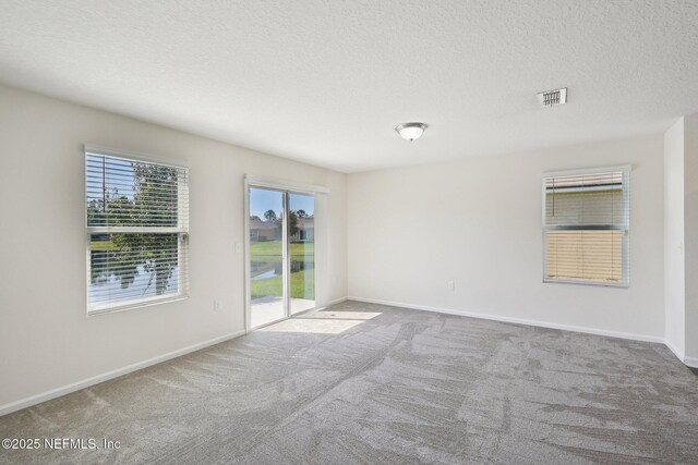 96 Cody St, Saint Augustine, FL 32084 - carpeted empty room featuring a textured ceiling and baseboards