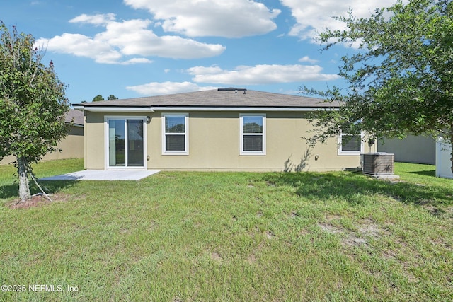 96 Cody St, Saint Augustine, FL 32084 - back of house with stucco siding, a lawn, a patio area, and central AC unit