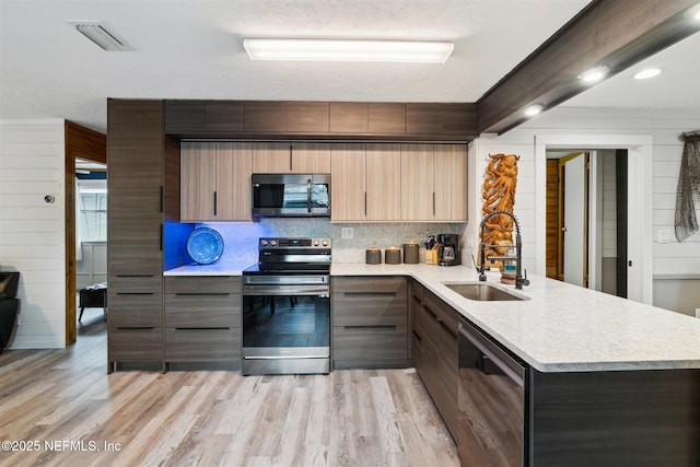 157 Smith Ln, Satsuma, FL 32189 - kitchen with stainless steel appliances, a sink, light countertops, and modern cabinets