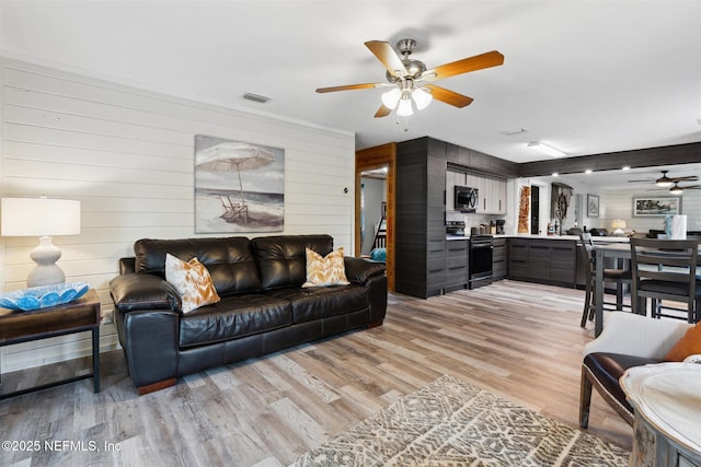 157 Smith Ln, Satsuma, FL 32189 - living area with ceiling fan, wood walls, and light wood finished floors
