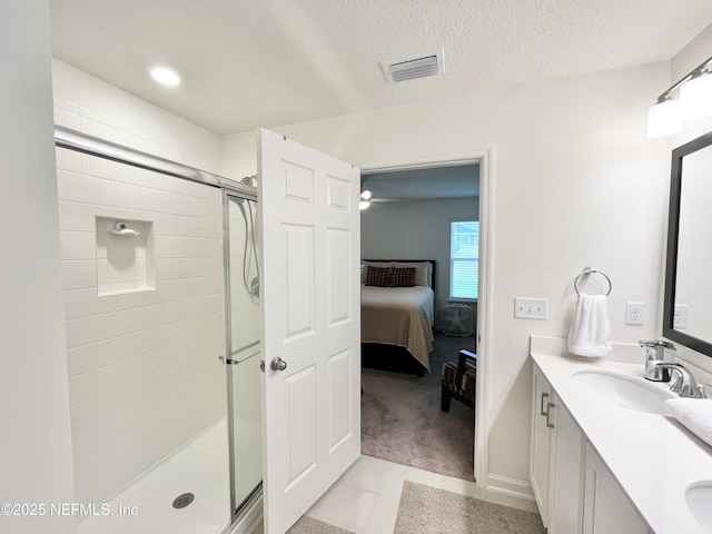 354 Boulder Ln, Saint Johns, FL 32259 - ensuite bathroom with vanity, a shower stall, tile patterned flooring, and a textured ceiling
