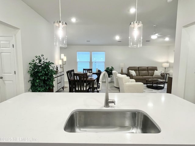 354 Boulder Ln, Saint Johns, FL 32259 - kitchen with a sink, pendant lighting, light stone counters, open floor plan, and recessed lighting