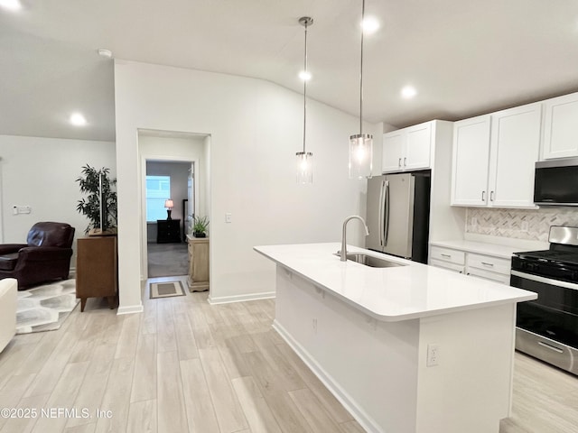 354 Boulder Ln, Saint Johns, FL 32259 - kitchen with appliances with stainless steel finishes, a sink, vaulted ceiling, light countertops, and light wood-type flooring