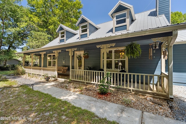 2708 Poinsettia Ave, Middleburg, FL 32068 - view of front of house featuring covered porch, a chimney, and metal roof