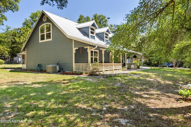 2708 Poinsettia Ave, Middleburg, FL 32068 - view of side of home with a porch, a yard, metal roof, and central air condition unit