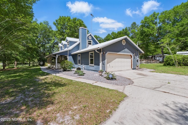 2708 Poinsettia Ave, Middleburg, FL 32068 - view of front of home with a garage, a front yard, concrete driveway, a chimney, and a porch