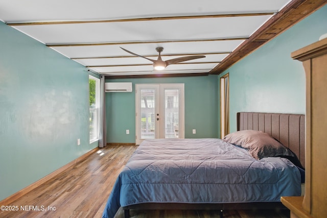 2708 Poinsettia Ave, Middleburg, FL 32068 - bedroom featuring a wall unit AC, wood finished floors, access to exterior, french doors, and baseboards