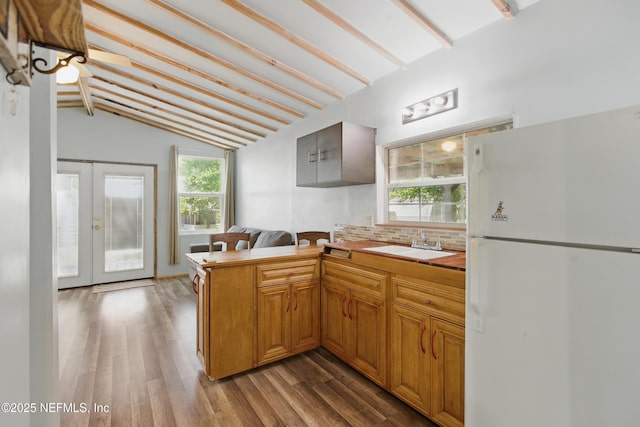 2708 Poinsettia Ave, Middleburg, FL 32068 - kitchen featuring freestanding refrigerator, a sink, wood finished floors, french doors, and a peninsula