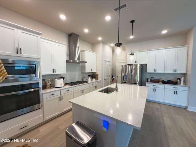 10065 Element Rd, Jacksonville, FL 32256 - kitchen with appliances with stainless steel finishes, wall chimney range hood, backsplash, a sink, and recessed lighting