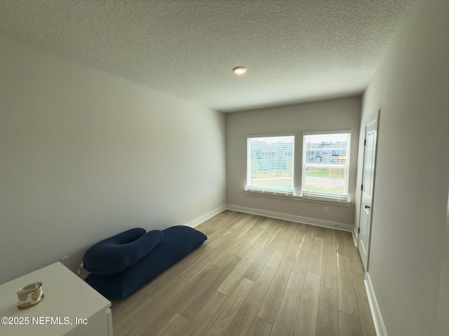10065 Element Rd, Jacksonville, FL 32256 - unfurnished room with light wood-style floors, baseboards, and a textured ceiling