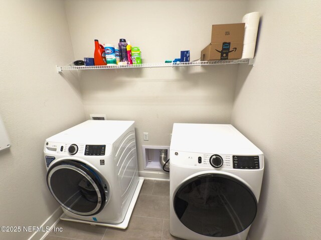 10065 Element Rd, Jacksonville, FL 32256 - laundry area with tile patterned flooring, independent washer and dryer, and baseboards