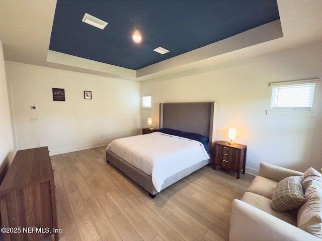 10065 Element Rd, Jacksonville, FL 32256 - bedroom with a raised ceiling, baseboards, and wood finished floors