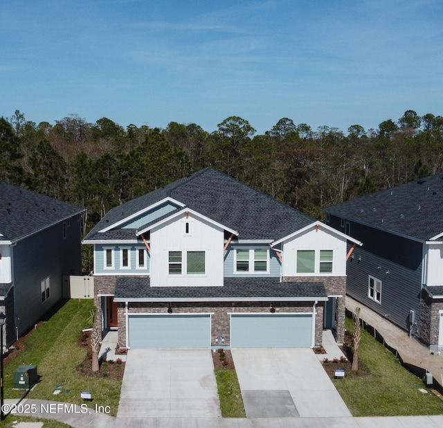 10065 Element Rd, Jacksonville, FL 32256 - view of front of house with stone siding, an attached garage, board and batten siding, and concrete driveway
