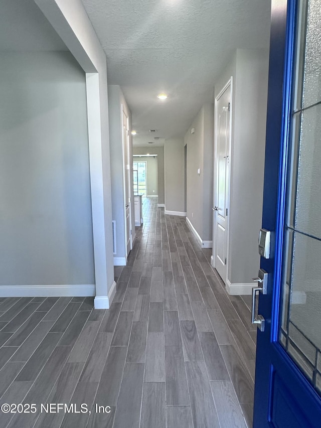 510 Broomsedge Cir, Saint Augustine, FL 32095 - hall with baseboards, dark wood finished floors, and a textured ceiling