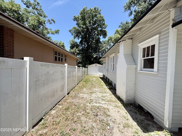 725 Calvert St, Jacksonville, FL 32208 - view of yard featuring driveway, a detached garage, and an outbuilding