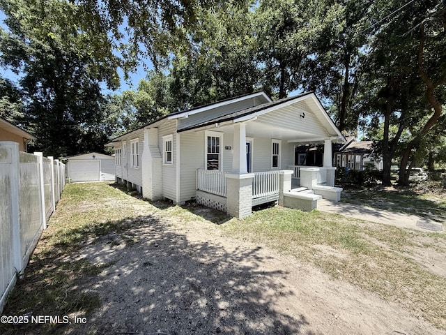 725 Calvert St, Jacksonville, FL 32208 - view of front of house featuring covered porch, driveway, an outdoor structure, and a garage