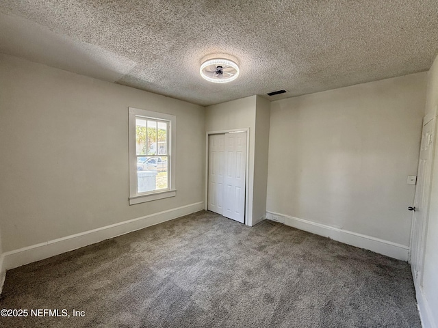 725 Calvert St, Jacksonville, FL 32208 - unfurnished bedroom featuring carpet floors, baseboards, a closet, and a textured ceiling