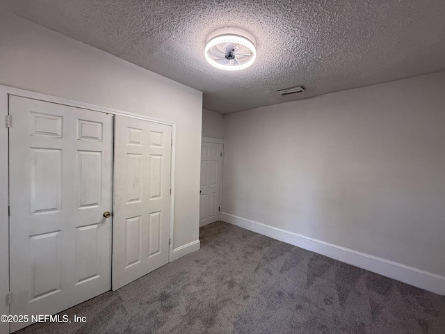 725 Calvert St, Jacksonville, FL 32208 - unfurnished bedroom with carpet floors, a textured ceiling, baseboards, and a closet