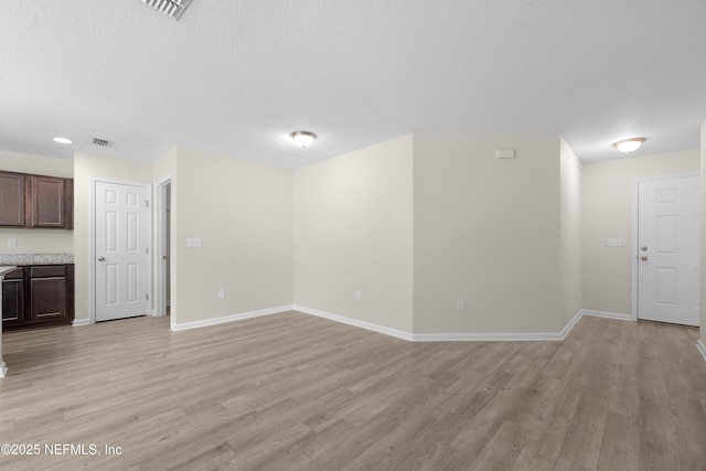7529 Hare Ave, Jacksonville, FL 32211 - unfurnished living room with light wood-style flooring and baseboards