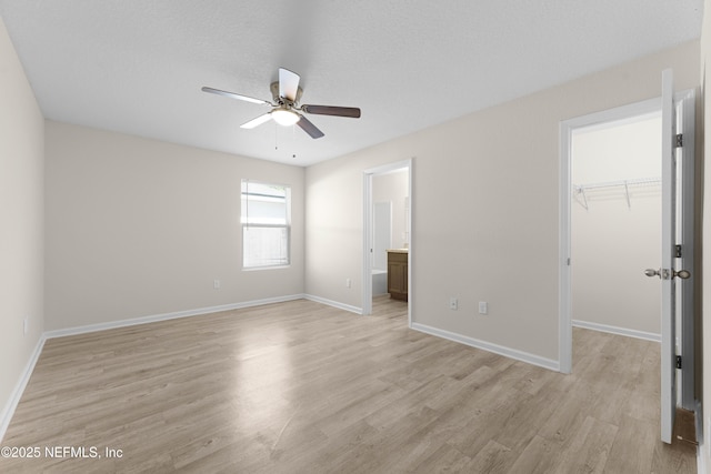 7529 Hare Ave, Jacksonville, FL 32211 - unfurnished bedroom featuring a walk in closet, light wood-style floors, a closet, baseboards, and ensuite bath