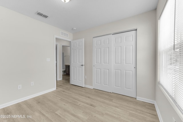 7529 Hare Ave, Jacksonville, FL 32211 - unfurnished bedroom with light wood-type flooring, baseboards, and a closet