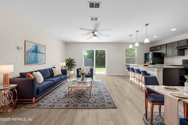 7529 Hare Ave, Jacksonville, FL 32211 - living room featuring light wood-type flooring, a ceiling fan, baseboards, and recessed lighting