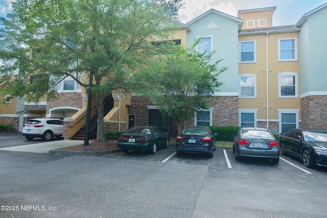 8539 W Gate Pkwy Unit 424, Jacksonville, FL 32216 - view of building exterior featuring uncovered parking