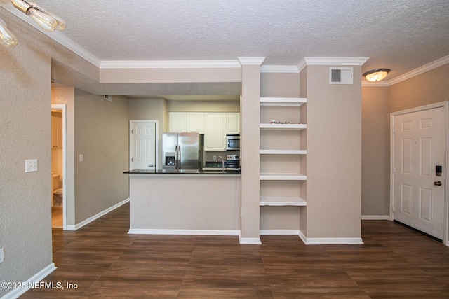 8539 W Gate Pkwy Unit 424, Jacksonville, FL 32216 - kitchen featuring stainless steel appliances, dark wood finished floors, a textured ceiling, dark countertops, and white cabinetry