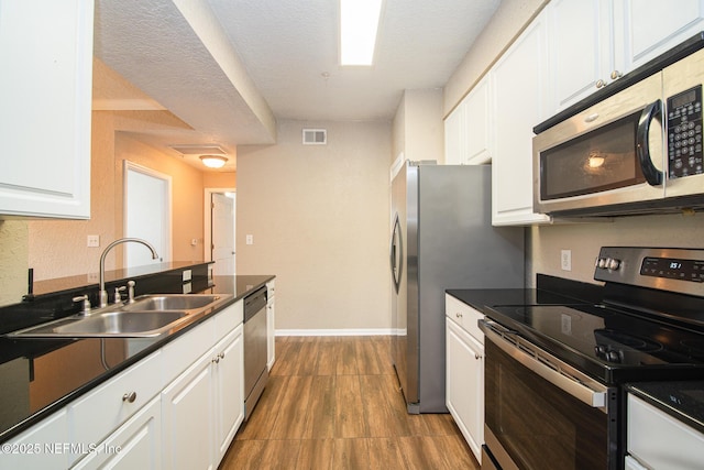 8539 W Gate Pkwy Unit 424, Jacksonville, FL 32216 - kitchen featuring stainless steel appliances, a sink, and white cabinets