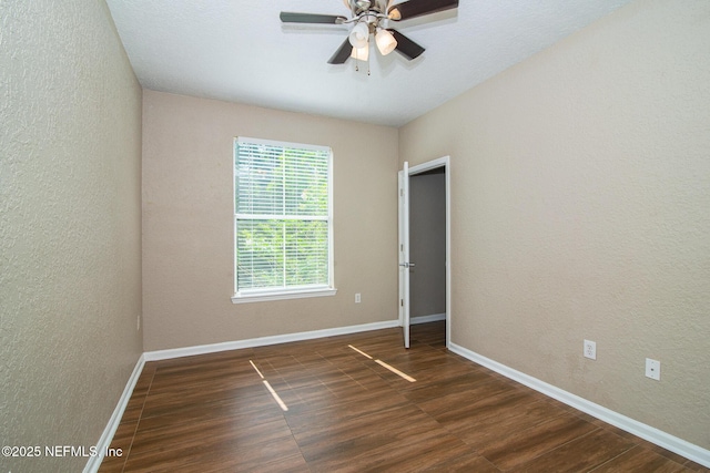 8539 W Gate Pkwy Unit 424, Jacksonville, FL 32216 - unfurnished room featuring wood finished floors, a textured wall, a ceiling fan, and baseboards