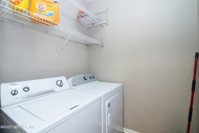 8539 W Gate Pkwy Unit 424, Jacksonville, FL 32216 - washroom featuring washing machine and clothes dryer and a textured wall