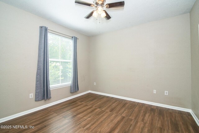 8539 W Gate Pkwy Unit 424, Jacksonville, FL 32216 - spare room with dark wood-type flooring, healthy amount of natural light, baseboards, and a ceiling fan