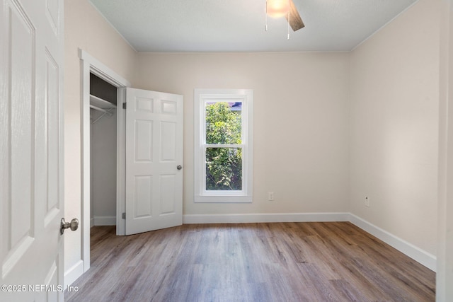 655 Linwood Ave, Jacksonville, FL 32206 - unfurnished bedroom with wood finished floors, baseboards, a ceiling fan, and a closet