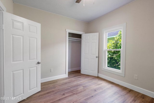 655 Linwood Ave, Jacksonville, FL 32206 - unfurnished bedroom with wood finished floors, baseboards, a closet, and a ceiling fan