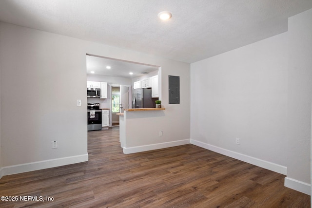 655 Linwood Ave, Jacksonville, FL 32206 - unfurnished living room with electric panel, dark wood-style flooring, baseboards, and recessed lighting