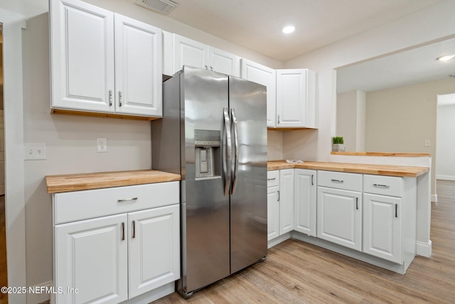 655 Linwood Ave, Jacksonville, FL 32206 - kitchen with wood counters, stainless steel fridge with ice dispenser, light wood-style flooring, white cabinetry, and a peninsula