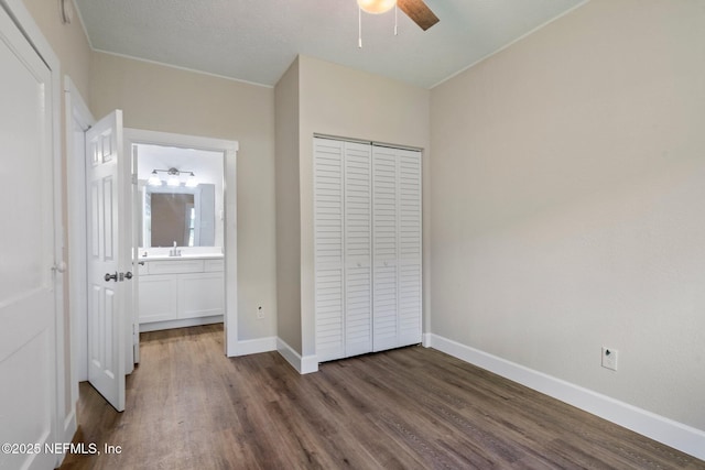 655 Linwood Ave, Jacksonville, FL 32206 - unfurnished bedroom featuring wood finished floors, a closet, baseboards, a sink, and a ceiling fan