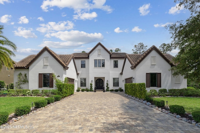 465 Deer Valley Dr, Ponte Vedra, FL 32081 - view of front of house with decorative driveway, stucco siding, a tile roof, a front yard, and a garage