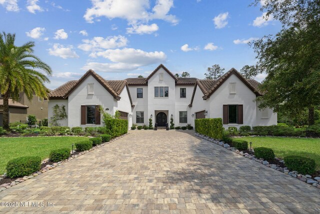 465 Deer Valley Dr, Ponte Vedra, FL 32081 - view of front of home featuring decorative driveway, stucco siding, a tiled roof, and a front lawn