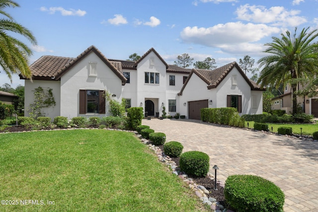 465 Deer Valley Dr, Ponte Vedra, FL 32081 - view of front of property with stucco siding, decorative driveway, a garage, a front yard, and a tile roof