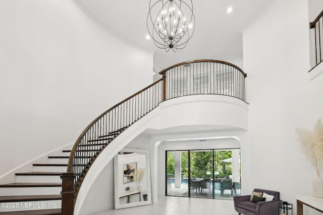 465 Deer Valley Dr, Ponte Vedra, FL 32081 - staircase featuring arched walkways, a towering ceiling, a chandelier, recessed lighting, and ornamental molding